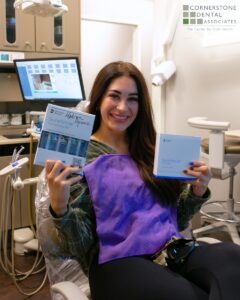 Cornerstone Dental Associates's patient holding up a clear aligners set
