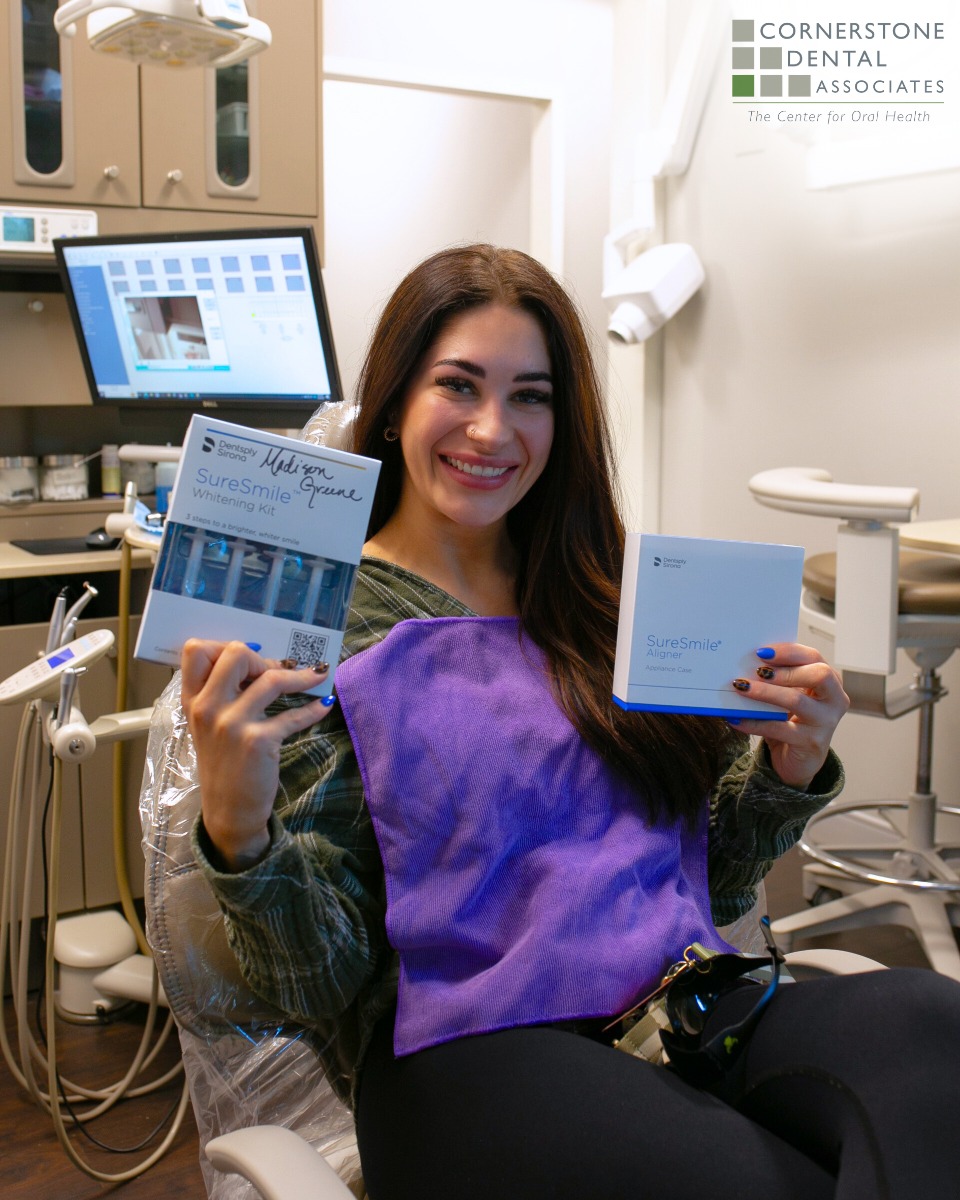 Cornerstone Dental Associates's patient holding up a clear aligners set